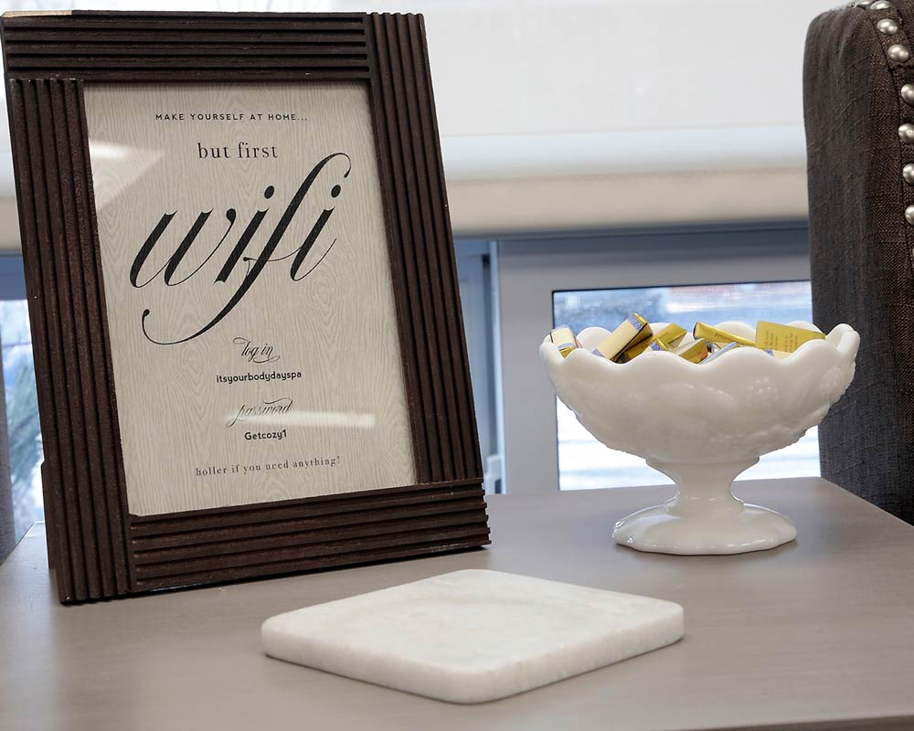 Closeup of a table with a bowl of chocolates and a WIFI info poster